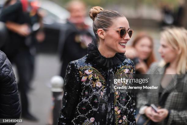 Olivia Palermo wearing patterned blazer and skirt and sunglasses outside Giambattista Valli Show on October 04, 2021 in Paris, France.