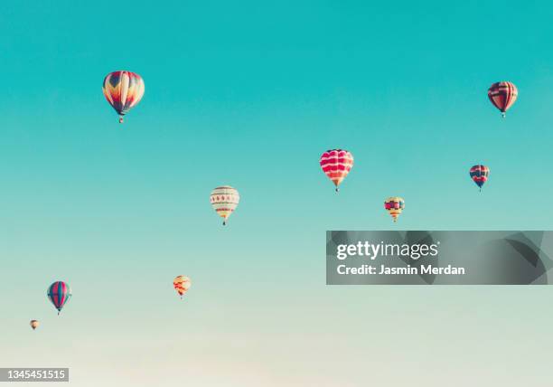 group of colorful hot air balloons - balloons in sky stock pictures, royalty-free photos & images