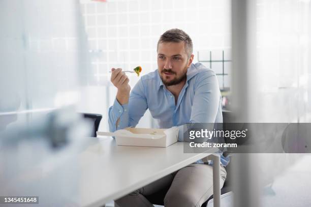 employee on a lunch break in office canteen - workplace canteen lunch stock pictures, royalty-free photos & images