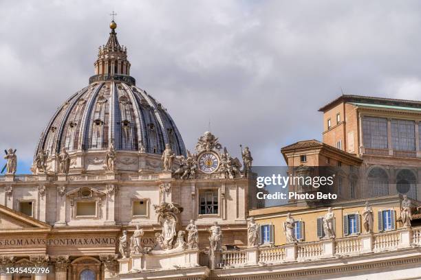 a detail of the majestic facade of st. peter's basilica with the michelangelo's dome in the vatican - st peter stock pictures, royalty-free photos & images