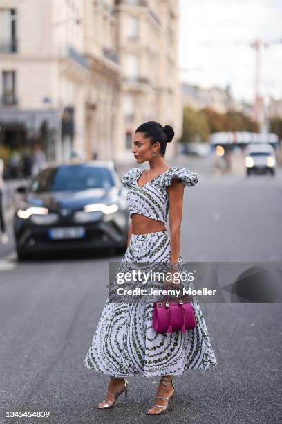 Jessica Verratti wearing black and white dress and pink bag outside Giambattista Valli Show on October 04, 2021 in Paris, France.