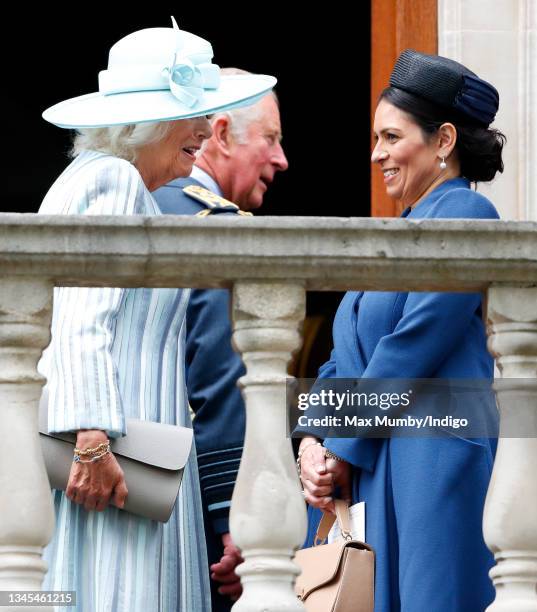 Camilla, Duchess of Cornwall and Home Secretary Priti Patel watch a Spitfire and Hurricane fly-past from the balcony of Church House after attending...