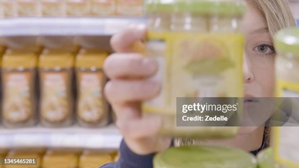 young woman shopping in a supermarket - labelling stock pictures, royalty-free photos & images