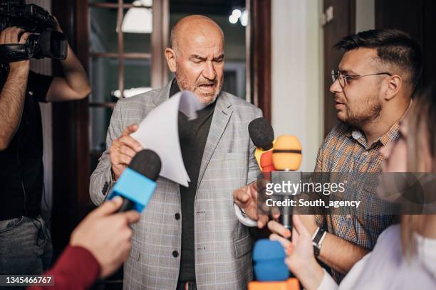 male politician talking to the press - angry politician stock pictures, royalty-free photos & images