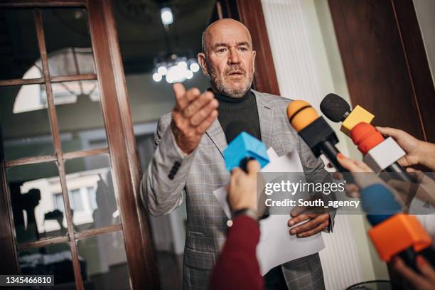 male politician talking to the press - politician talking stock pictures, royalty-free photos & images