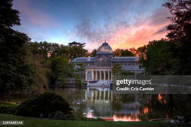 crystal palace in retiro park in madrid at sunset - madrid landmarks stock pictures, royalty-free photos & images