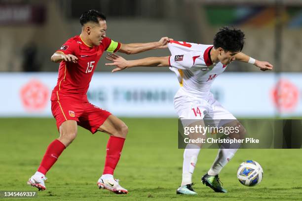 Xi Wu of China PR and Nguyen Hoang Duc of Vietnam compete for the ball during the FIFA World Cup Asian Qualifier final round Group B match between...