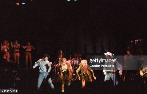 George Michael and Andrew Ridgeley of English pop duo Wham with backing singers Helen DeMacque and Shirlie Holliman perform on stage at Hammersmith...