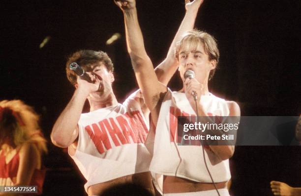 George Michael and Andrew Ridgeley of English pop duo Wham perform on stage at Hammersmith Odeon on October 28th, 1983 in London, United Kingdom.