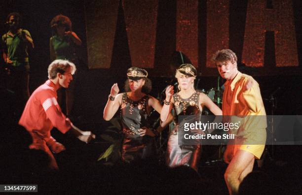 George Michael and Andrew Ridgeley of English pop duo Wham with backing singers Helen DeMacque and Shirlie Holliman perform on stage at Hammersmith...