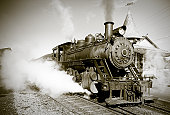 Sepia Toned Vintage Steam Engine Locomotive Train Leaving Station