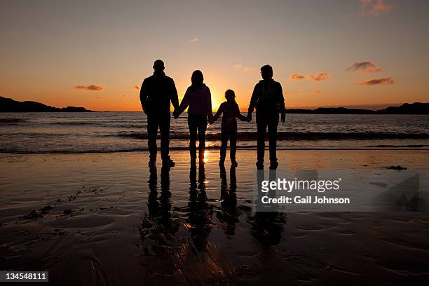 familiy on beach - family in silhouette stock pictures, royalty-free photos & images