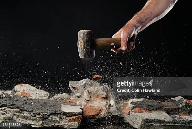 smashing brick work with hammer - demolishing bildbanksfoton och bilder
