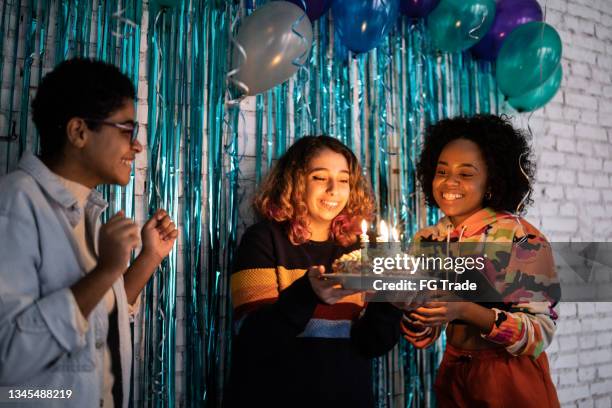 girls celebrating birthday at home - achttien jaar stockfoto's en -beelden