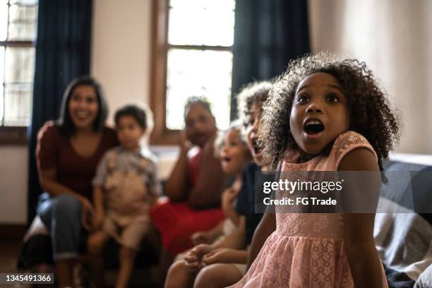 surprised kids on christmas day (or watching tv) at home - interracial cartoon stock pictures, royalty-free photos & images