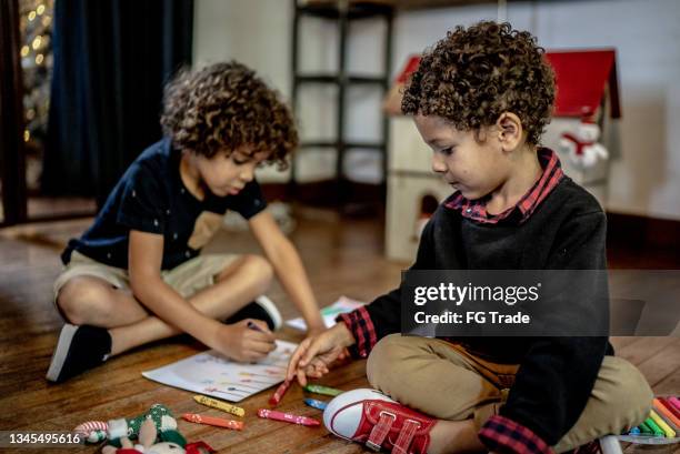 brothers drawing together at home - kids crayon drawing stock pictures, royalty-free photos & images