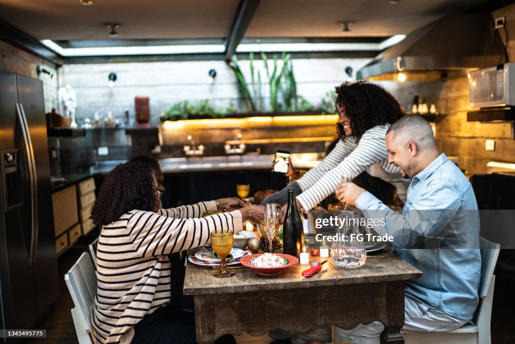 Mid adult women serving Christmas dinner at home