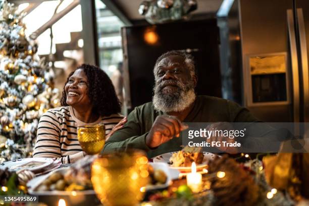 grandparents on christmas dinner at home - old man woman christmas stock pictures, royalty-free photos & images