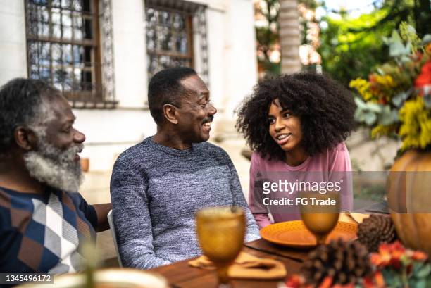 family reunited on the table for thanksgiving at home - african tradition stock pictures, royalty-free photos & images