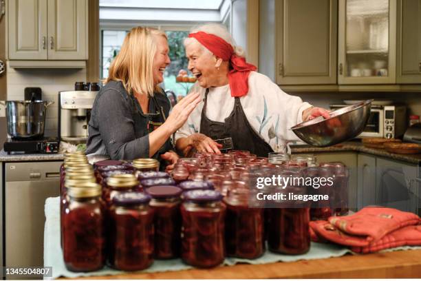 family preparing preserved beets - canning stock pictures, royalty-free photos & images