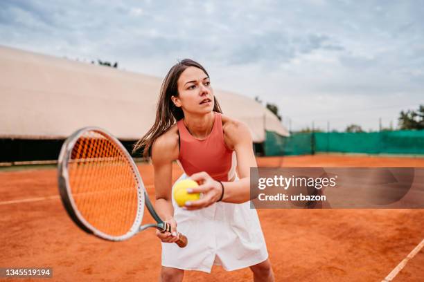 female tennis player practice on court - young tennis player stock pictures, royalty-free photos & images