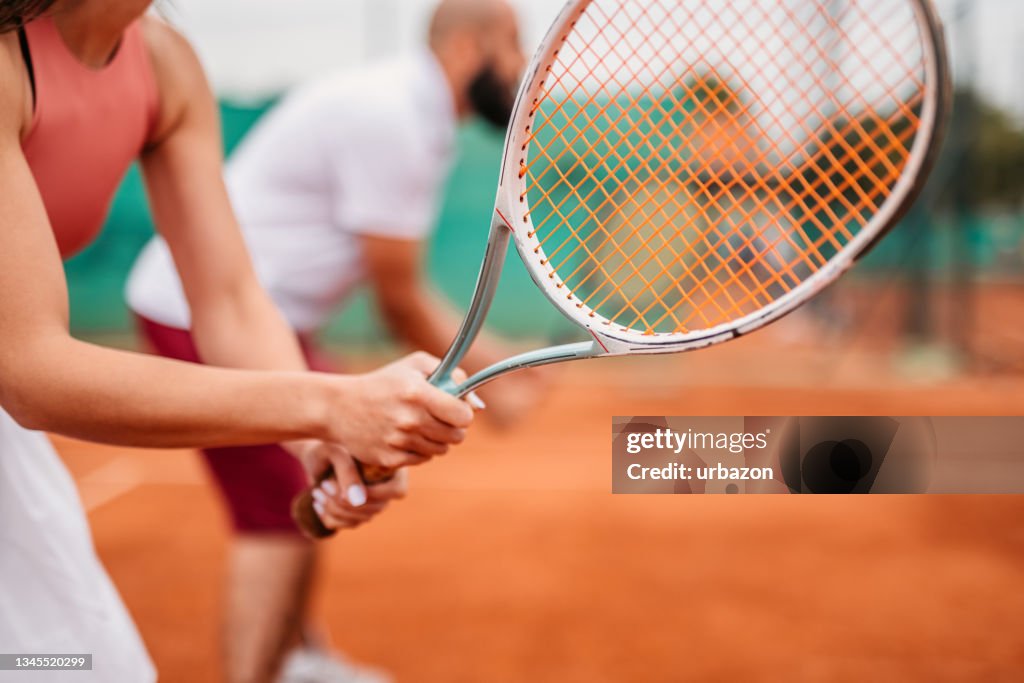 Tennis racket in hand of female tennis player