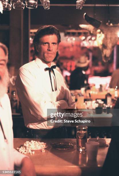 View of American actor Ted Danson during the filming of 'Little Treasure' , Los Angeles, California, 1984. Partially visible at extreme left is Burt...