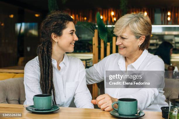 mom and adult daughter hug and laugh. - european womens handball championship stock pictures, royalty-free photos & images