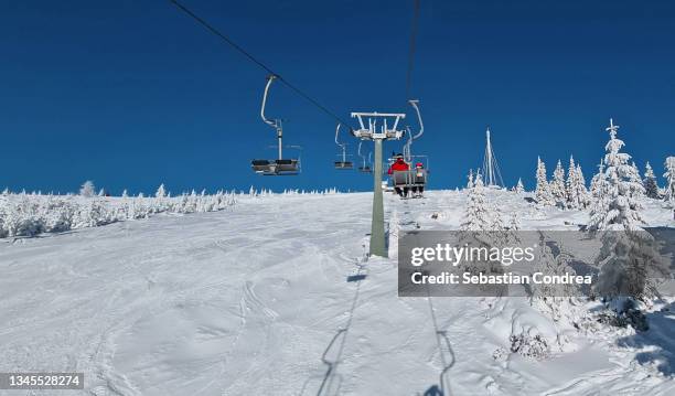 view of the sky slope climbing with chairlift, - alps romania stock pictures, royalty-free photos & images
