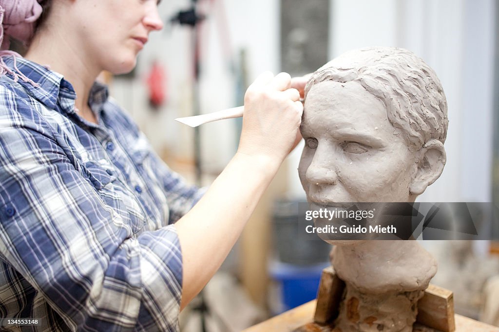 Sculptor working on head sculpture