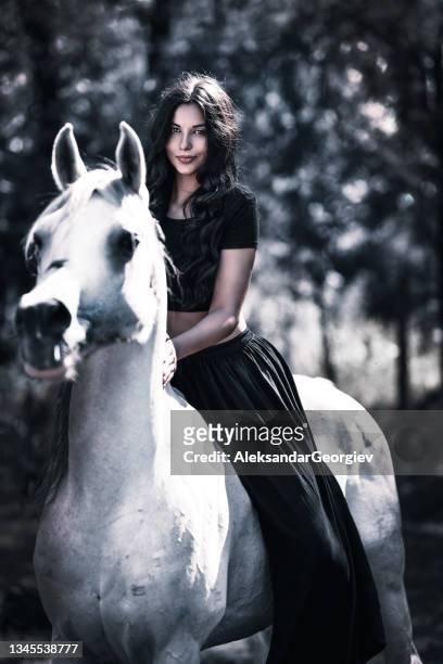 cute gypsy female riding her white horse on ranch - gipsy stock pictures, royalty-free photos & images