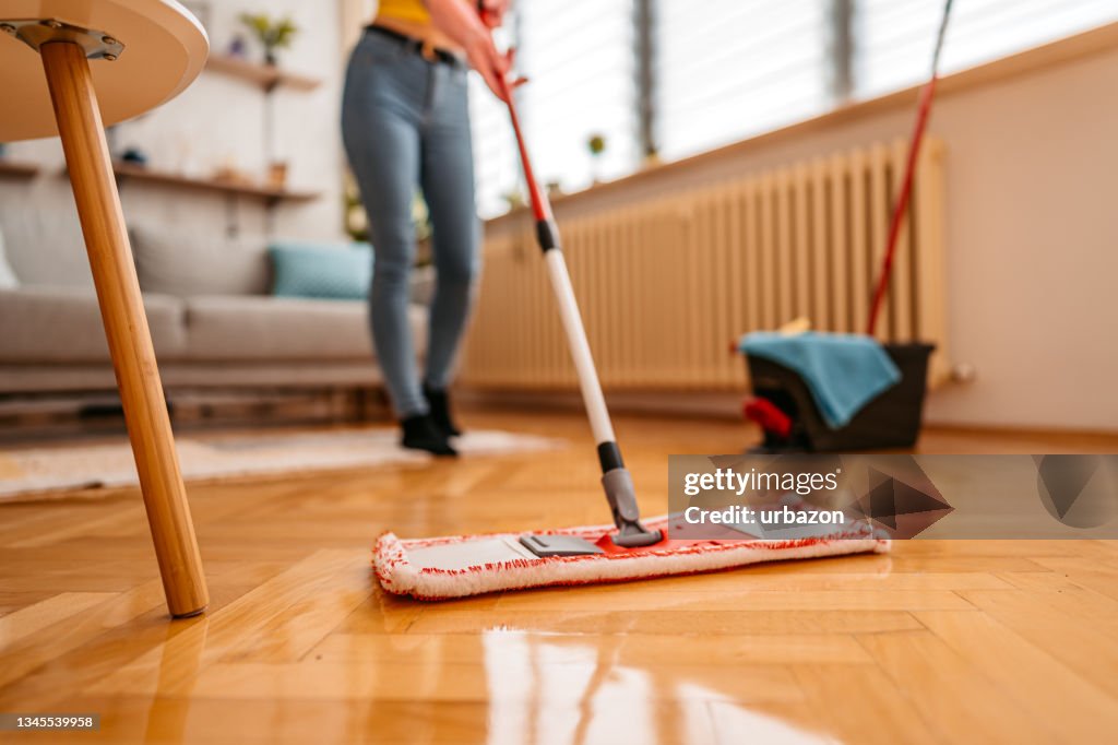 Cleaning parquet floor with wet mop