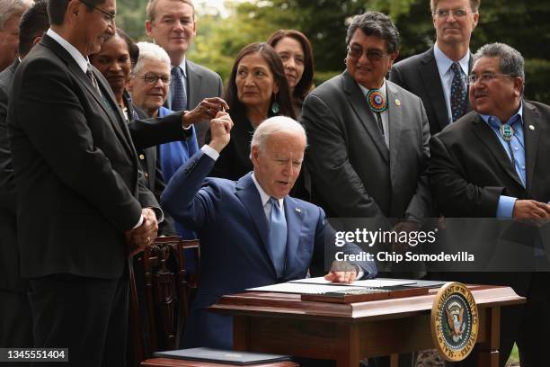 President Joe Biden gives away pens he used to sign proclamations expanding the areas of three national monuments at the White House on October 08,...