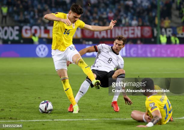 Ianis Hagi of Romania is challenged by Leon Goretzka of Germany during the 2022 FIFA World Cup Qualifier match between Germany and Romania at Imtech...