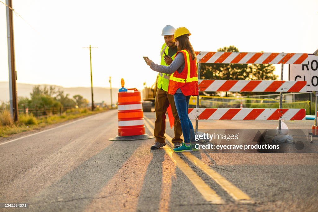 Digital Tablet Communication in the Field Hispanic Workers Setting Barriers and Directing Traffic Street Road and Highway Construction Photo Series