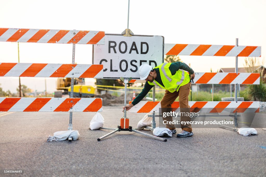 Hispanic Workers Setting Barriers and Directing Traffic Street Road and Highway Construction Photo Series