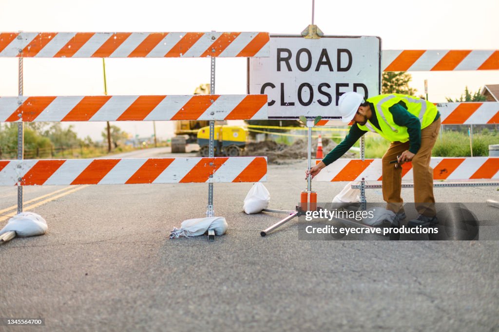 Hispanic Workers Setting Barriers and Directing Traffic Street Road and Highway Construction Photo Series