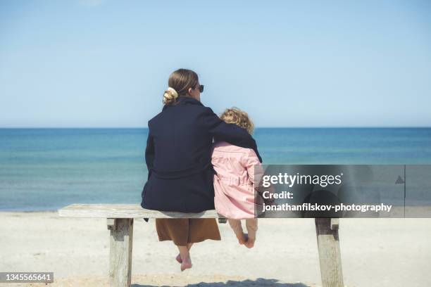 mother and daughter outdoors on sandy beach - beach denmark stock pictures, royalty-free photos & images
