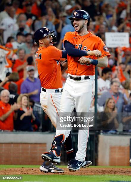 Carlos Correa of the Houston Astros congratulates Kyle Tucker after Tucker hit a home run during the 7th inning of Game 2 of the American League...
