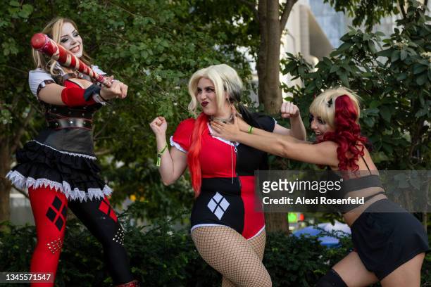 Cosplayers dressed as Harley Quinn act out scenes on Day 2 of New York Comic Con at Javits Center on October 08, 2021 in New York City. Comic Con has...