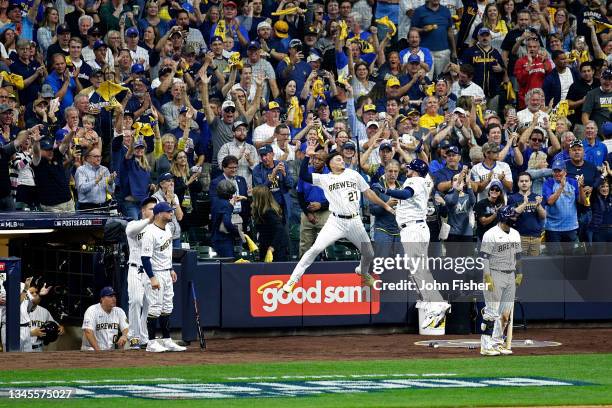 Willy Adames jumps to high five Rowdy Tellez of the Milwaukee Brewers after a two run home run in the seventh inning against the Atlanta Braves...