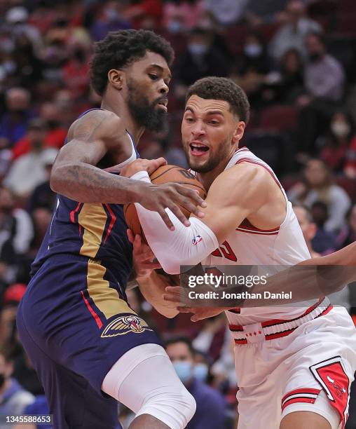 Zach LaVine of the Chicago Bulls gets tied up by Naji Marshall of the New Orleans Pelicans at the United Center on October 08, 2021 in Chicago,...