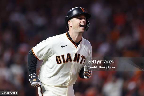 Buster Posey of the San Francisco Giants reacts after hitting a two-run home run off Walker Buehler of the Los Angeles Dodgers during the first...