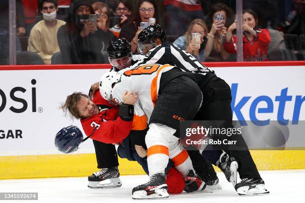 Nick Jensen of the Washington Capitals and Nicolas Aube-Kubel of the Philadelphia Flyers fight in the third period of a preseason game at Capital One...