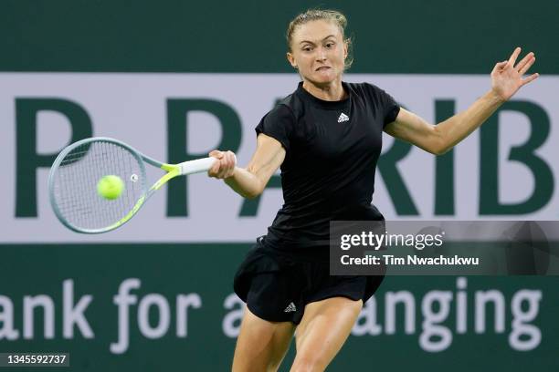 Aliaksandra Sasnovich of Belarus returns a shot to Emma Raducanu of Great Britain during the BNP Paribas Open at the Indian Wells Tennis Garden on...