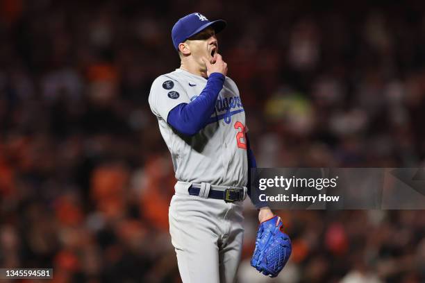 Walker Buehler of the Los Angeles Dodgers reacts after allowing a single by Tommy La Stella of the San Francisco Giants during the third inning of...