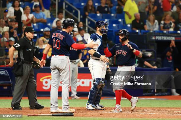 Hunter Renfroe and Christian Vazquez of the Boston Red Sox celebrate scoring on a two RBI single by Enrique Hernandez in the ninth inning against the...