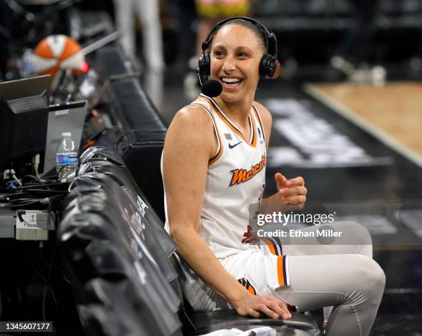 Diana Taurasi of the Phoenix Mercury reacts to cheering fans as she waits for a television interview after the team's 87-84 victory over the Las...