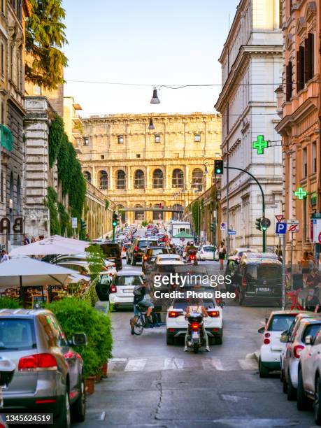 a famous street in the monti district in rome with a beautiful view of the colosseum in the background - rome colosseum stock pictures, royalty-free photos & images