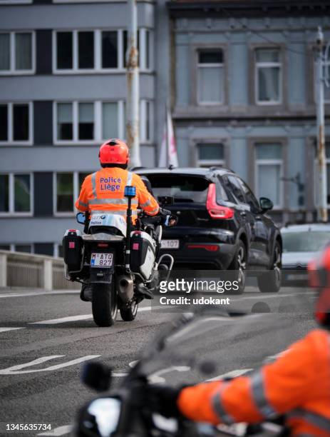 police on motorcycles cross bridge in the center of liège - belgium police stock pictures, royalty-free photos & images